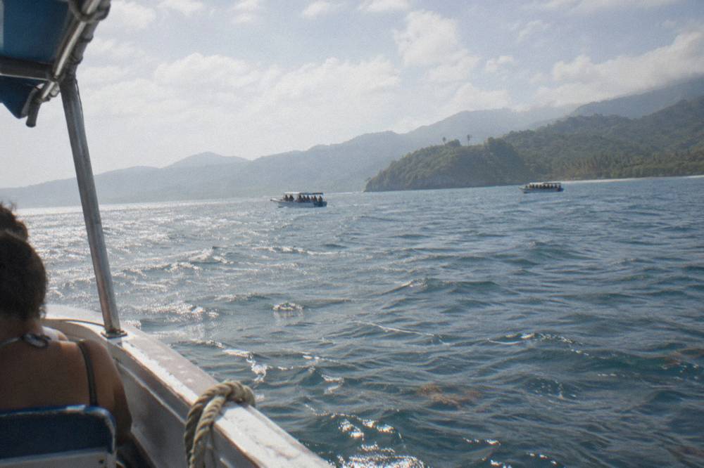 Two whale watching boats at a distance on open water in Samana Bay