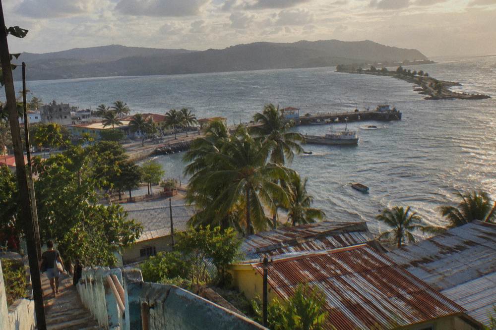 Coastal highway curving along green hills toward the Samana peninsula